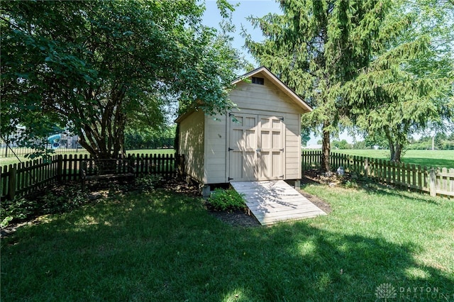 view of outbuilding featuring a lawn