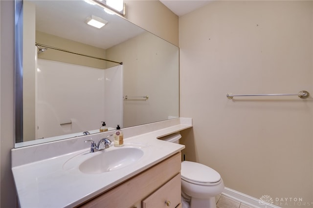 bathroom featuring tile patterned flooring, vanity, walk in shower, and toilet