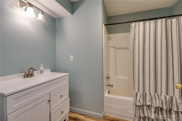 bathroom featuring shower / bathtub combination with curtain, sink, and hardwood / wood-style flooring