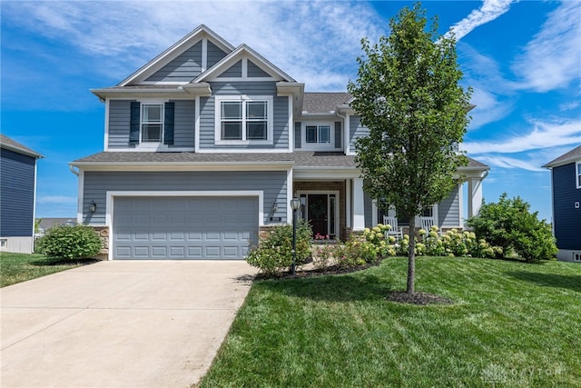 craftsman house featuring a front yard and a garage