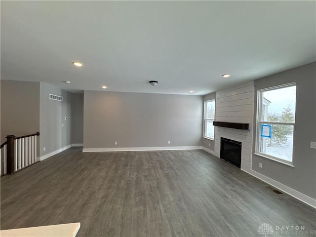 unfurnished living room featuring dark hardwood / wood-style flooring