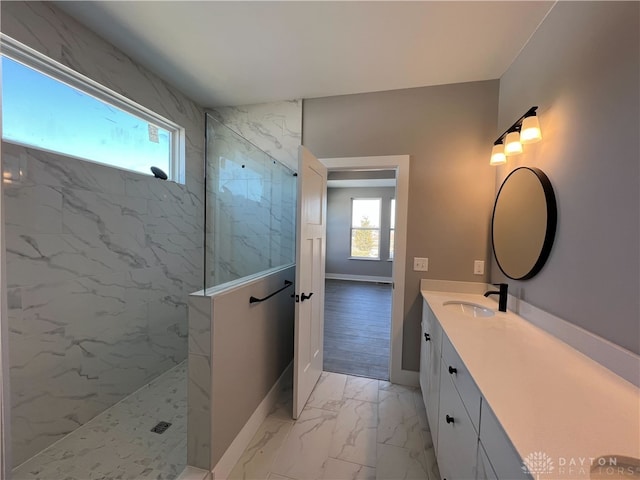 bathroom featuring vanity and tiled shower