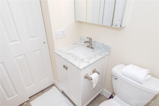 bathroom with toilet and vanity