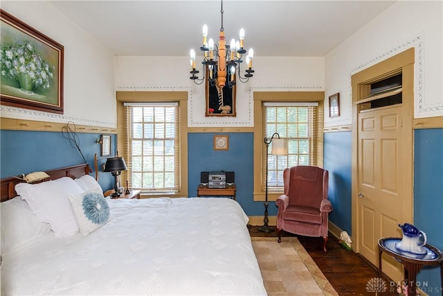 bedroom featuring wood-type flooring, a closet, and a chandelier