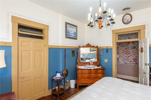 bedroom featuring dark hardwood / wood-style flooring and a chandelier