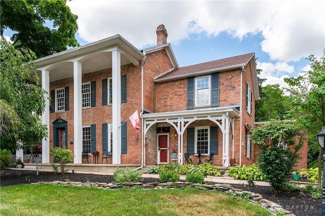 view of front of property with a front yard and covered porch