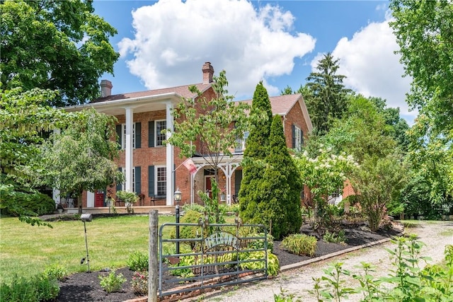 greek revival house featuring a front yard