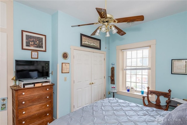 bedroom with ceiling fan and a closet