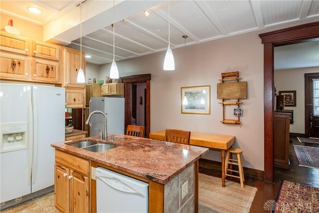 kitchen with pendant lighting, sink, white appliances, a kitchen island with sink, and light stone countertops