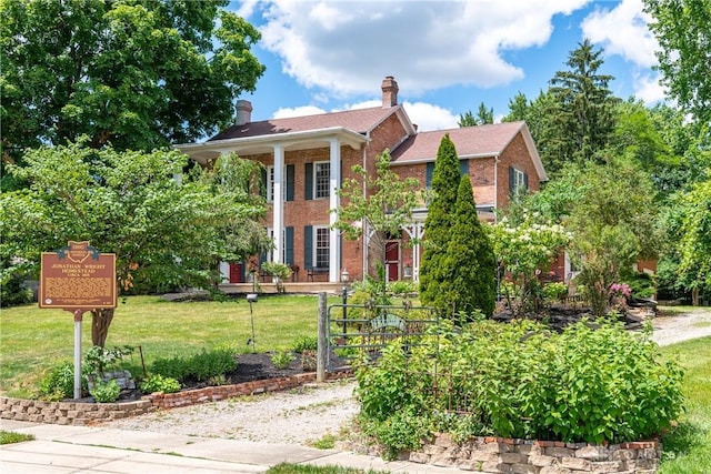 greek revival inspired property featuring a front yard