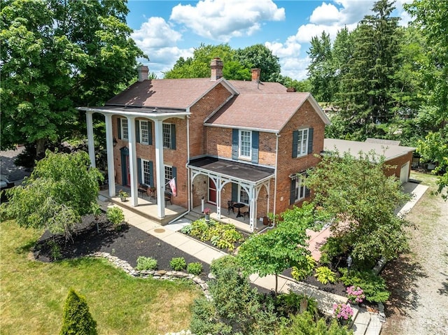 rear view of property with a lawn and a patio area