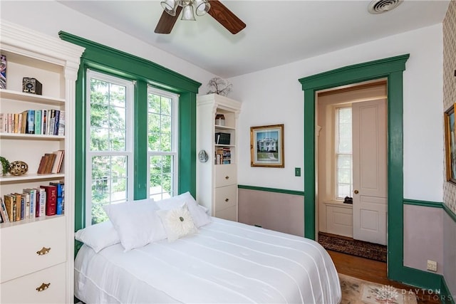 bedroom with ceiling fan and hardwood / wood-style flooring