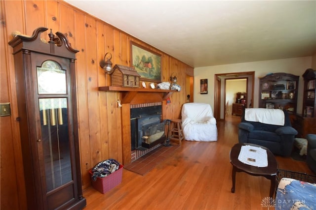 living room featuring hardwood / wood-style flooring and wooden walls