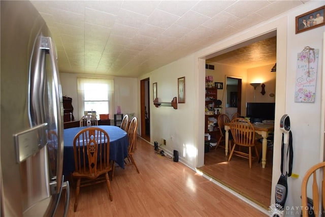 dining room with light hardwood / wood-style floors