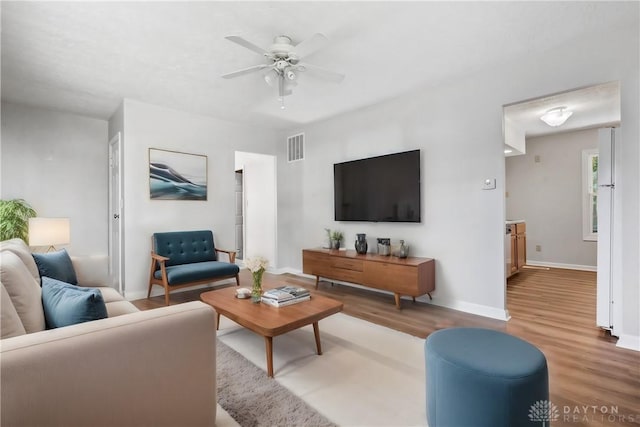 living room featuring ceiling fan and light wood-type flooring