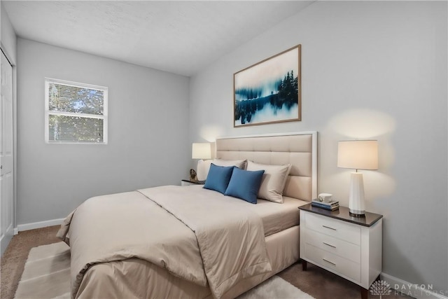 bedroom featuring dark carpet