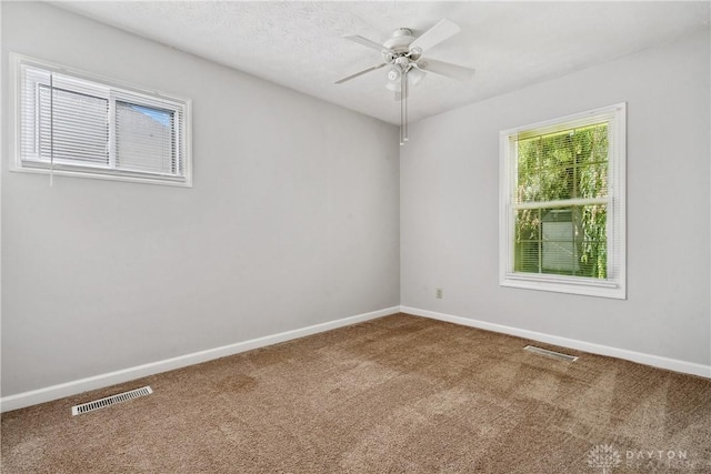 spare room featuring carpet floors and ceiling fan