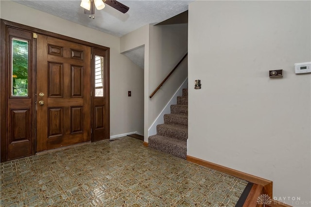 entryway featuring ceiling fan and a textured ceiling