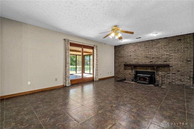 unfurnished living room featuring ceiling fan, a textured ceiling, and a wood stove