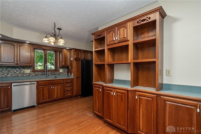 kitchen featuring sink, light hardwood / wood-style flooring, dishwasher, black refrigerator, and tasteful backsplash