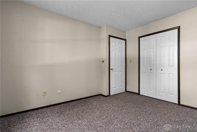 unfurnished bedroom featuring a textured ceiling and carpet