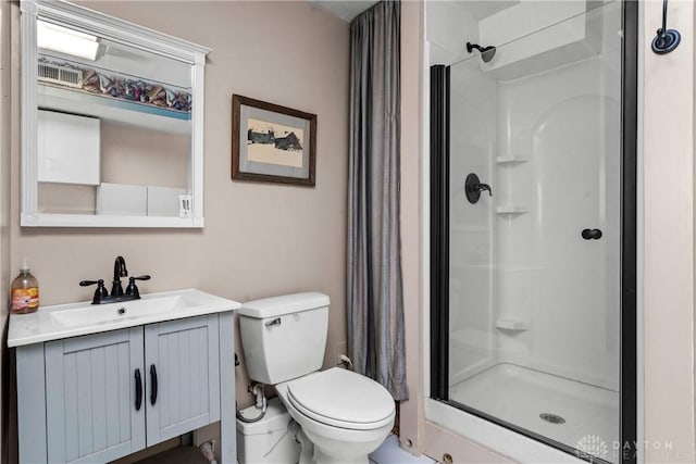 bathroom with vanity, toilet, and a shower