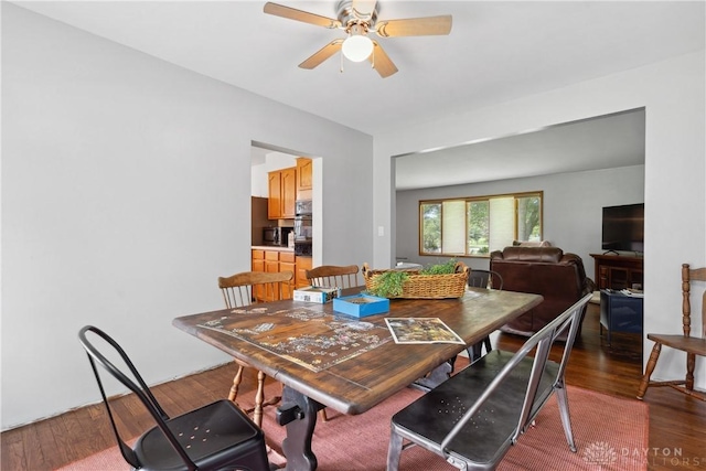 dining space featuring wood-type flooring and ceiling fan