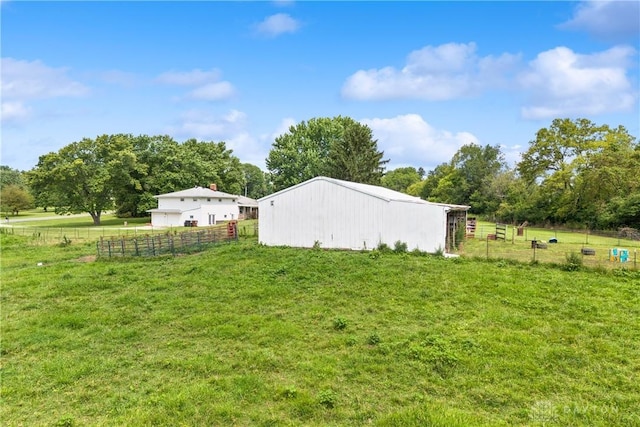 view of yard featuring an outbuilding and a rural view