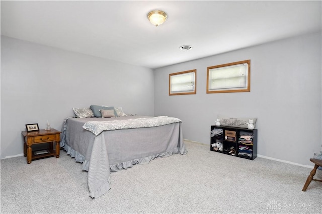 bedroom featuring light carpet