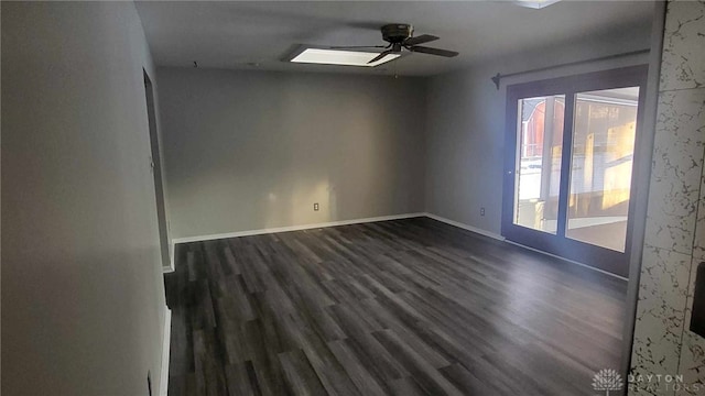 spare room featuring dark wood-type flooring and ceiling fan