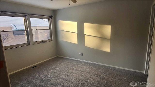 carpeted spare room featuring ceiling fan