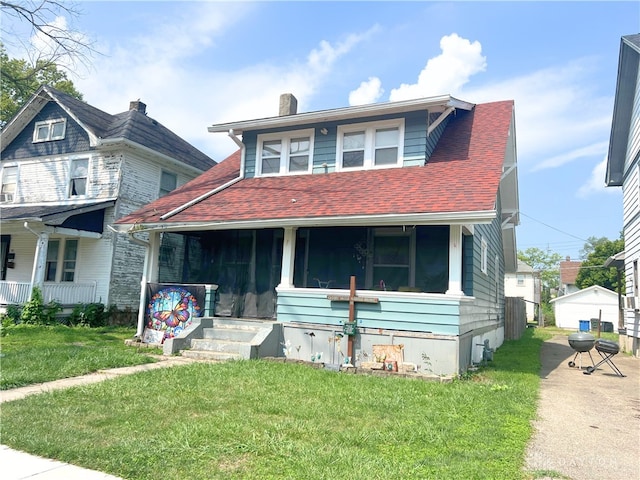 view of front of home with a porch and a front yard