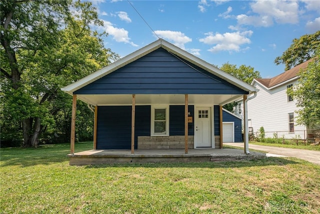 bungalow-style house featuring covered porch and a front lawn