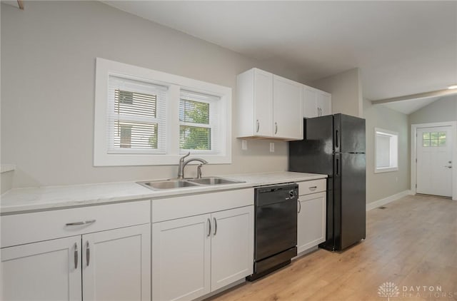 kitchen with black appliances, white cabinetry, sink, and a wealth of natural light