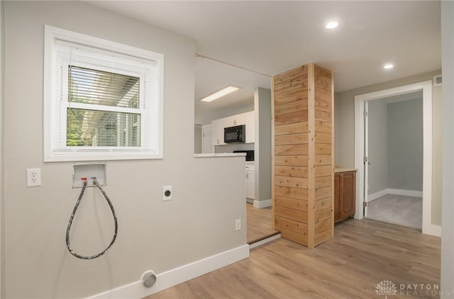 laundry area with hookup for an electric dryer, washer hookup, and light wood-type flooring