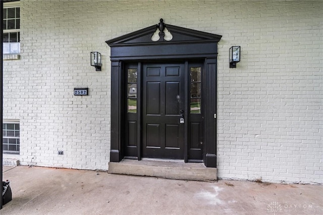 entrance to property with brick siding