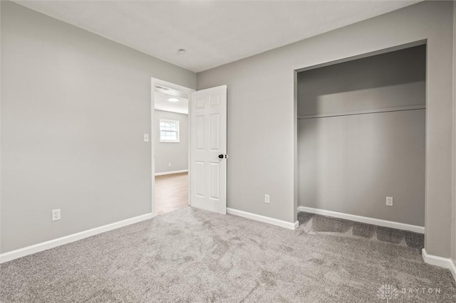 unfurnished bedroom featuring a closet, carpet flooring, and baseboards