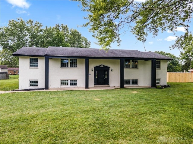 split foyer home with a front yard, fence, and a patio