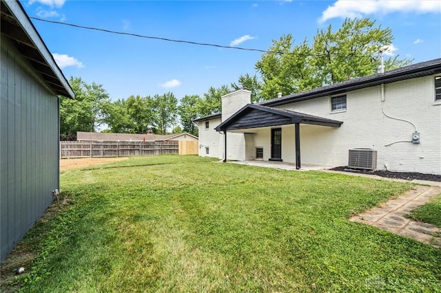 view of yard with a patio area, cooling unit, and fence