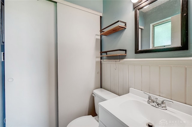 bathroom featuring toilet and vanity