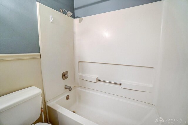 bathroom with shower / tub combination and toilet