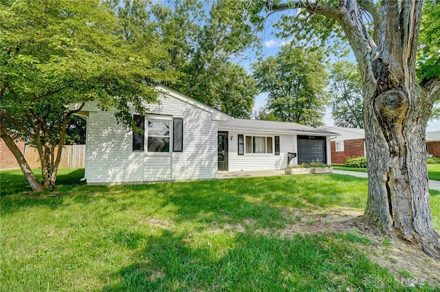 ranch-style house with a garage and a front yard