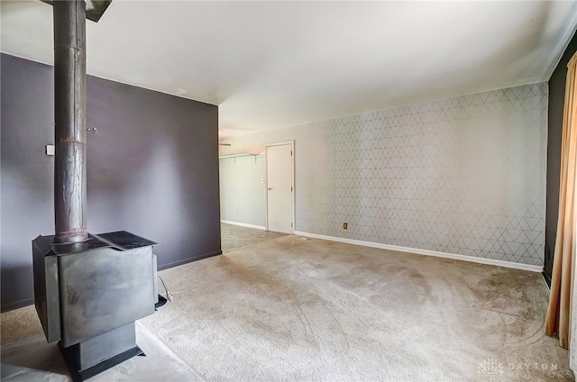 living room featuring a wood stove and carpet floors