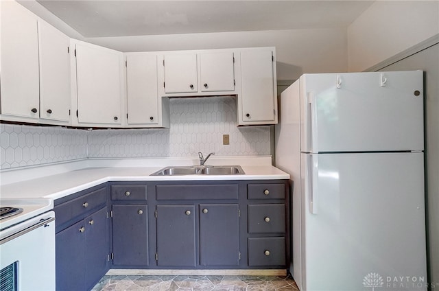 kitchen with light tile patterned flooring, white appliances, white cabinets, backsplash, and sink