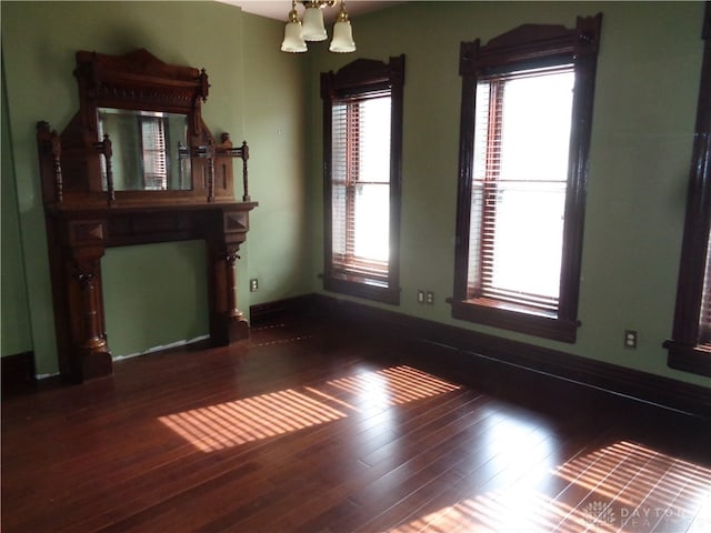 interior space with plenty of natural light and hardwood / wood-style floors