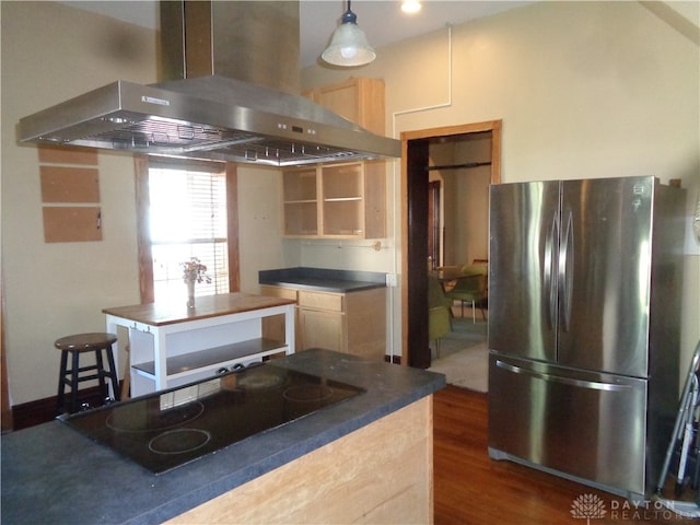 kitchen with pendant lighting, black electric stovetop, stainless steel refrigerator, island range hood, and dark wood-type flooring