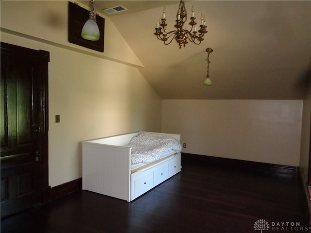 unfurnished bedroom featuring vaulted ceiling and dark hardwood / wood-style floors