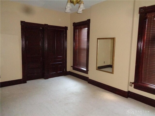 unfurnished room with light colored carpet