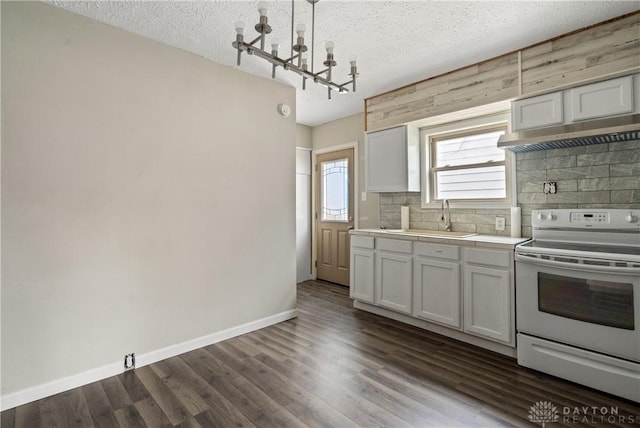 kitchen featuring pendant lighting, a textured ceiling, white cabinets, and white range with electric stovetop