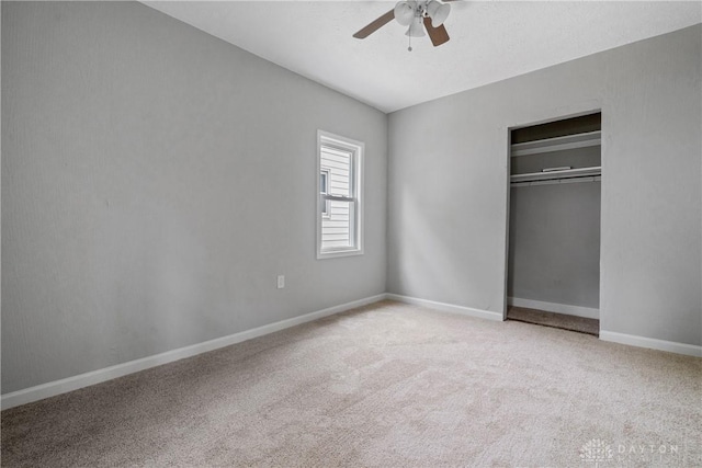 unfurnished bedroom with light carpet, a closet, and ceiling fan